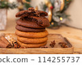 Home made giant cookies on wooden table with pieces of star anise and cinnamon 114255737