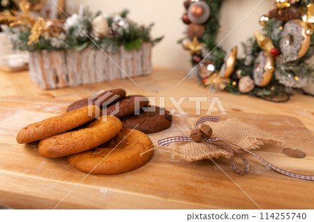Home made giant cookies on wooden table with pieces of star anise and cinnamon Home made giant cookies on wooden table with pieces of star anise and cinnamon 114255740