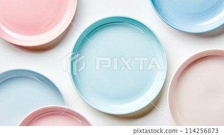 Assortment of ceramic plates in pastel colors on a white background. Flat lay composition with copy space. 114256873