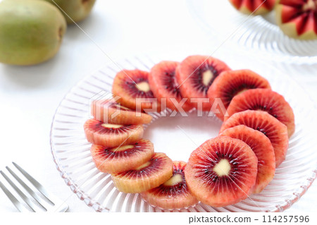 Sliced red kiwi fruit on a glass plate Ruby red kiwi fruit 114257596