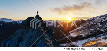 Adult adventurous woman standing on top of a snow peak. Mountain adventure artwork 114257600