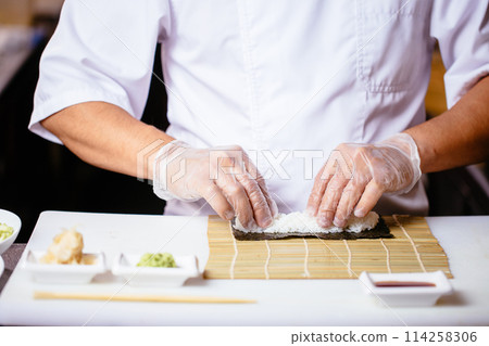 close up cropped photo. male chef is putting the rice to cook set 114258306