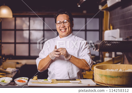 cheerful positive guy in white uniform taking off gloves cheerful positive guy in white uniform taking off gloves 114258312
