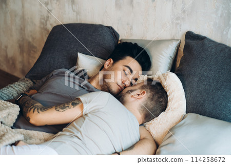 A homosexual couple on bed in studio with loft interior 114258672
