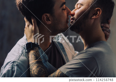 Cay couple enjoy togetherness indoors, kiss each other Cay couple enjoy togetherness indoors, kiss each other 114258748