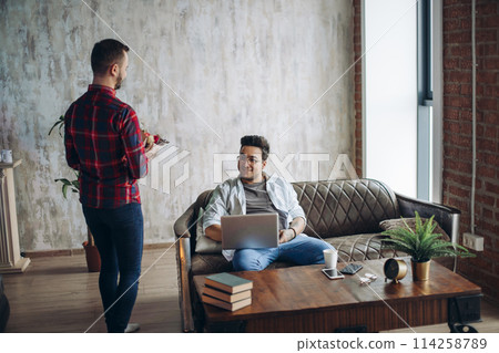Romantic homo man presenting flowers to his beloved partner, Valentine's Day Romantic homo man presenting flowers to his beloved partner, Valentine's Day 114258789