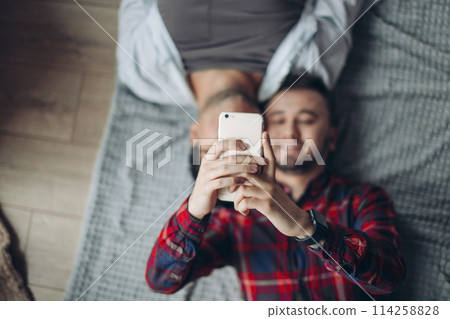 gay couple making selfie in bed 114258828