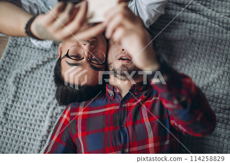 gay couple making selfie in bed 114258829