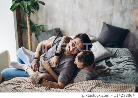 Two sexy caucasian gay guys hugging and having fun in bed indoors Two sexy caucasian gay guys hugging and having fun in bed indoors 114258864