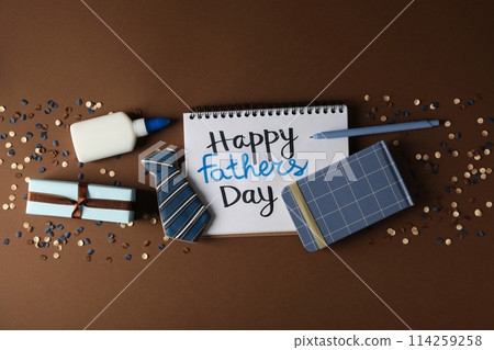 Father's day concept, gifts and greetings, on a brown background. Father's day concept, gifts and greetings, on a brown background. 114259258