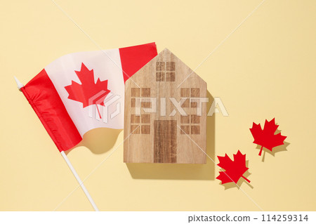 A wooden house with the flag of Canada A wooden house with the flag of Canada 114259314