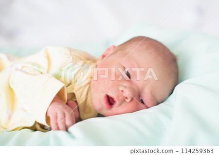 Newborn baby boy in hosptal cot 114259363