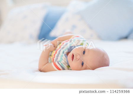Little baby on white bed Little baby on white bed 114259366