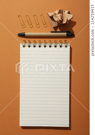 Notebook and stationery on the table, top view. 114259415