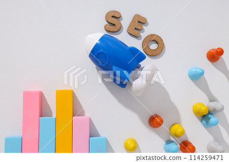 Diagram, letters and toy rocket on light background, top view 114259471