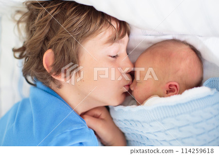 Siblings meet newborn baby in hospital Siblings meet newborn baby in hospital 114259618