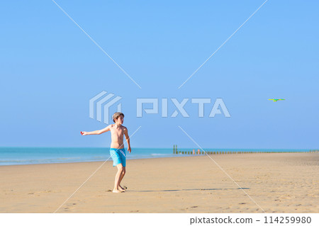 Kids playing on beach. Children play at sea. Kids playing on beach. Children play at sea. 114259980