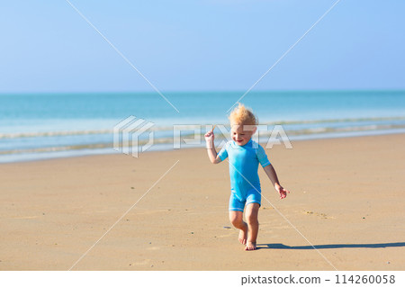Kids playing on beach. Children play at sea. 114260058