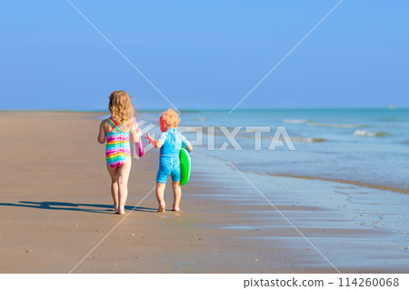 Kids playing on beach. Children play at sea. Kids playing on beach. Children play at sea. 114260068