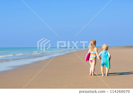 Kids playing on beach. Children play at sea. 114260070