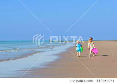 Kids playing on beach. Children play at sea. Kids playing on beach. Children play at sea. 114260074
