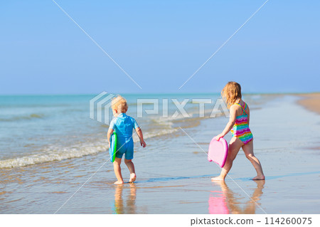 Kids playing on beach. Children play at sea. Kids playing on beach. Children play at sea. 114260075