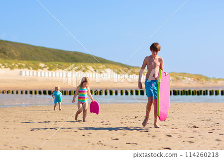 Kids playing on beach. Children play at sea. Kids playing on beach. Children play at sea. 114260218