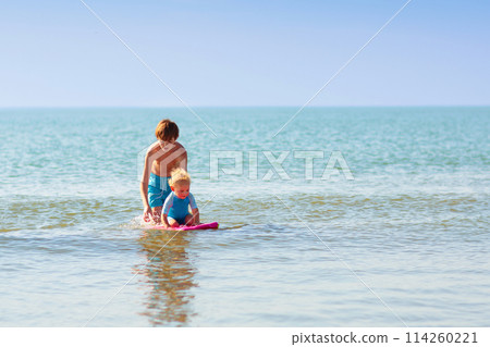 Kids playing on beach. Children play at sea. Kids playing on beach. Children play at sea. 114260221