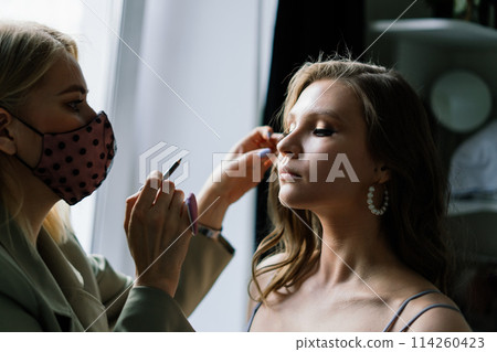 Make-up artist work in her studio with model Make-up artist work in her studio with model 114260423