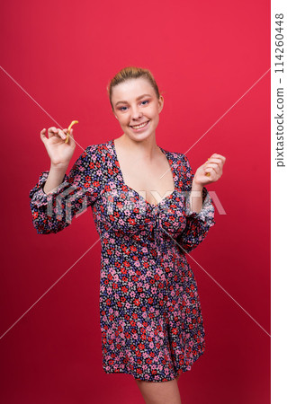 Unhealthy eating. Junk food concept. Portrait of fashionable young woman holding fried potato 114260448