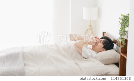 Man yawning while sleeping Man yawning while sleeping 114261368