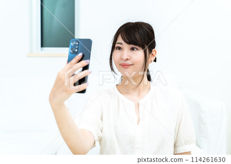 A woman taking self-taking 114261630