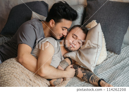 A homosexual couple on bed in studio with loft interior A homosexual couple on bed in studio with loft interior 114262208