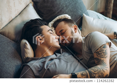 A homosexual couple on bed in studio with loft interior 114262282
