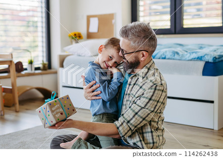 Dad get a handmade gift from little son, present wrapped in diy homemade wrapping paper. Happy Fathers day concept. 114262438