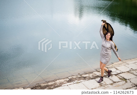 Portrait of beautiful mature woman with on vacation. Hands in the air, happiness. Portrait of beautiful mature woman with on vacation. Hands in the air, happiness. 114262673