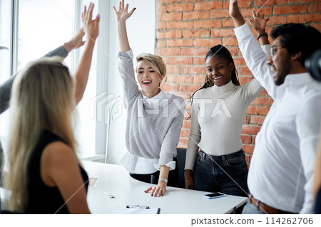 cheerful mixed race office workers celebrating successful contract 114262706