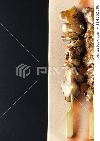 Yakitori and liver photographed against a black background 114262886