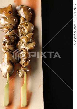 Yakitori and liver photographed against a black background 114262887