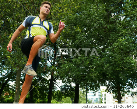 Young man running in park Young man running in park 114263640