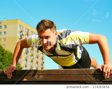 Man doing push ups outdoor Man doing push ups outdoor 114263658