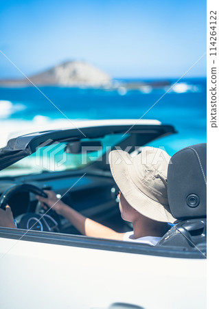 Young man driving an open car on a sunny day Young man driving an open car on a sunny day 114264122