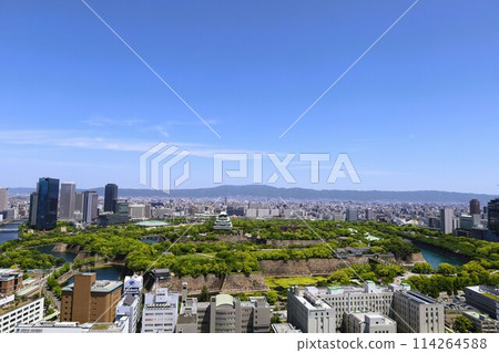 Golden Week, early May, young leaves, Osaka Castle Park in early summer, Osaka Castle with fresh greenery as seen from the lounge of a high-rise apartment Golden Week, early May, young leaves, Osaka Castle Park in early summer, Osaka Castle with fresh greenery as seen from the lounge of a high-rise apartment 114264588