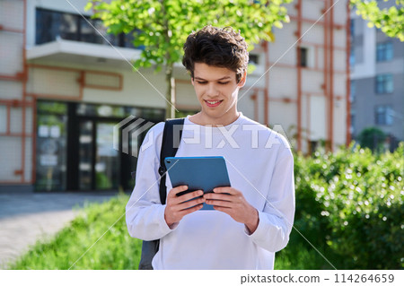 Young guy college student using digital tablet outdoor 114264659