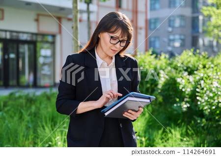 Portrait of business mature woman with digital tablet, outdoor 114264691