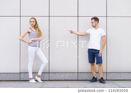 Man point finger at girl. 114265058
