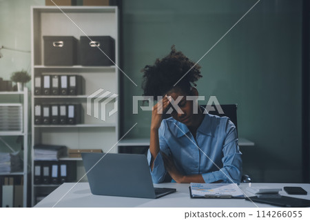 business woman sitting at work stressed , out working hard Feeling stressed out and dizzy from your job business woman sitting at work stressed , out working hard Feeling stressed out and dizzy from your job 114266055