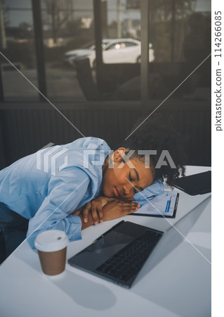 Sad tired young asian lady thinking, sleep at laptop, suffering from overwork, stress in room interior. Deadline, problems in study, work, business, freelance at home new normal with tech 114266085