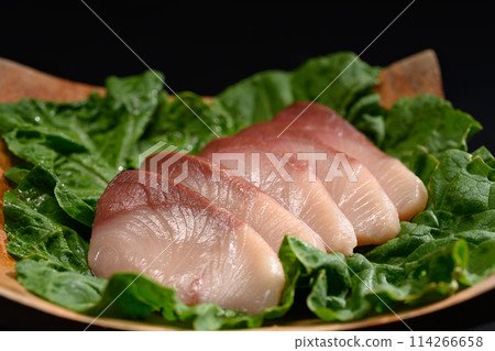Fresh raw Hamachi sashimi or yellowtail fish served on wooden plate. Traditional Japanese food Fresh raw Hamachi sashimi or yellowtail fish served on wooden plate. Traditional Japanese food 114266658