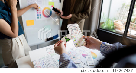 Brainstorm team of creative web graphic designer planning. Creative designers present ux ui to team. Designers team working meeting in office Brainstorm team of creative web graphic designer planning. Creative designers present ux ui to team. Designers team working meeting in office 114267427